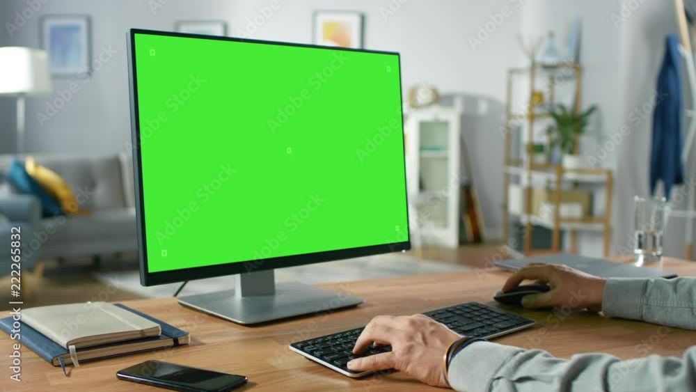 Poster over the shoulder shot of professional freelancer working on green mockup screen personal computer f