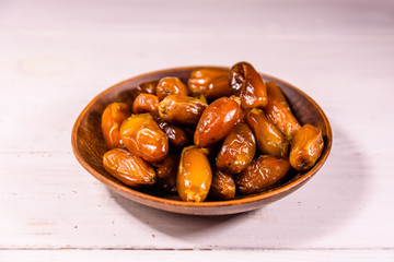 Date fruits on the white wooden table