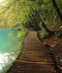 Wooden path leading along beautiful lake