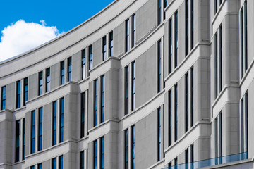 Part of modern building with blue windows closeup. European architecture example