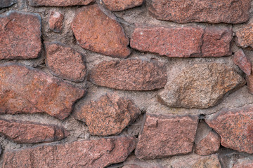 Wall made from red stone. Background, texture