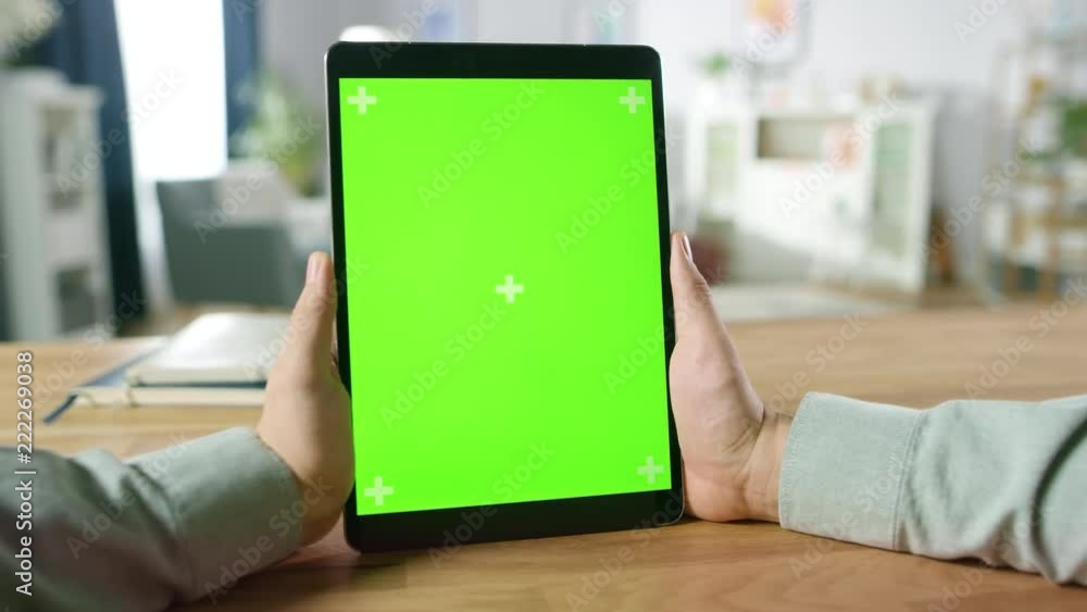 Poster first person shot of man using hand gestures on green mock-up screen digital tablet computer in port