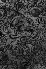 Black decorative plaster close up. Detailed texture of wall in macro in grayscale. Designer background in monochrome.