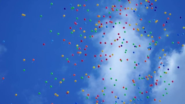 variety colorfull baloons in the scky with clouds and sun