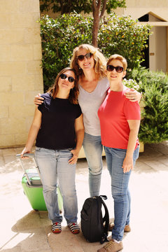 Three happy 40 years old  real women traveling together