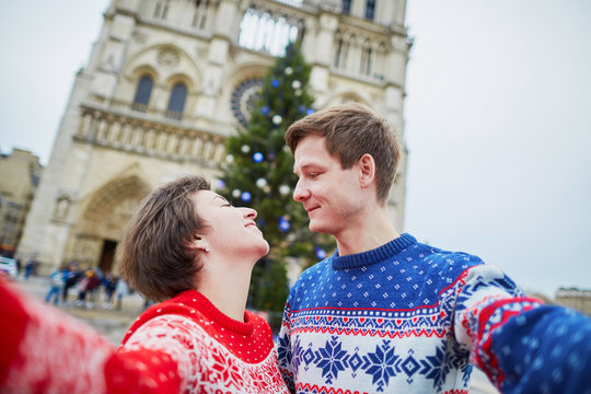 Couple taking selfie in Paris on a Christmas day