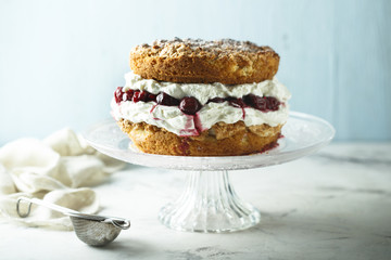 Almond cake with whipped cream and cherries