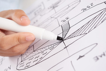 Closeup shot of hand of anonymous person using marker pen to draw business diagram