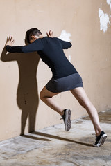 Woman push the wall