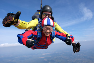 Skydiving. Tandem jump is with asian girl.
