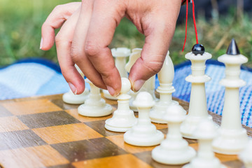 chess game step with white pawn in human hand situation
