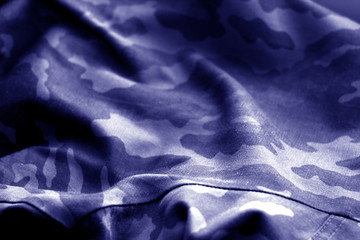 Military uniform pattern with blur effect in blue tone.