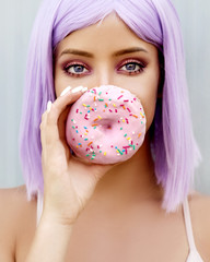 Young  woman holding pink donut