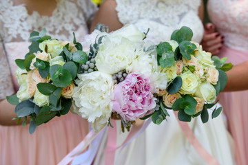 Wedding bouquet in bridal and bridesmaids hands