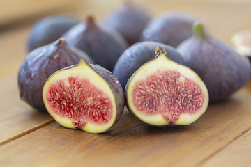 Ripe figs on a wooden table, close-up. Fresh fruit - figs.