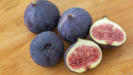 Ripe figs on a wooden table, close-up. Fresh fruit - figs.