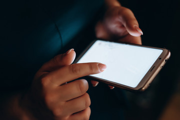 human's hand holding smart phone with blur background.