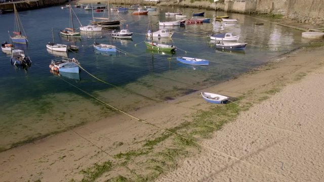 Harbour of Mousehole in Cornwall with colorful fishing boats 