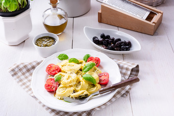 ravioli with spinach filling, grated cheese and cocktail tomatoes