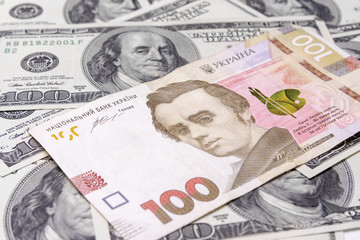 Banknotes are dollars and Ukrainian hryvnias close-up. Portrait of the president on the money. The concept of economy