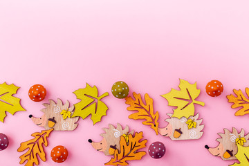 Multicolor wooden figures autumn elements like leafs, pumpkins, mushrooms, hedgehogs. Fall background with copy space.
