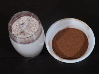 Traditional winter eggnog with milk, rum and cinnamon, sprinkle with grated nutmeg, selective focus,Glass mugs filled with homemade egg nog with cinnamon sticks, Cinnamon Milk, Dalchini Milk