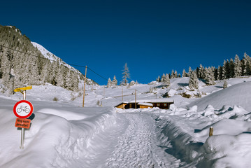 Small hut in Alps mountains in winter scenery.