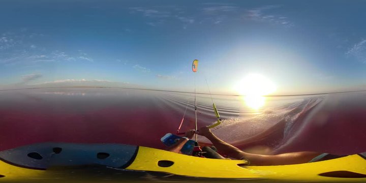 Dawn on a pink lake, 360 degrees. A man is kitesurfing on a wakeboard