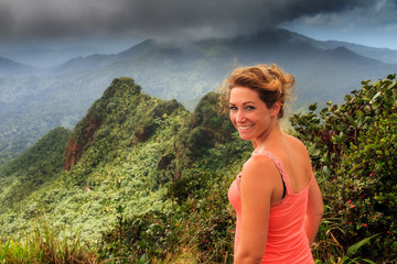 Adventurous young woman on top of the beautiful jungle of the El Yunque national forest in Puerto...
