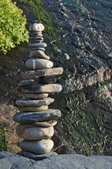 Fototapeta premium Pile of pebble stones and waterfall. Zen and Harmony themes