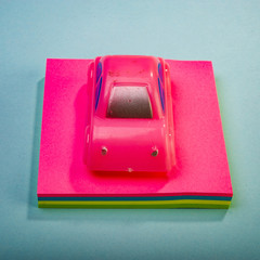 toy car rests on a stack of stickers. Web banner.