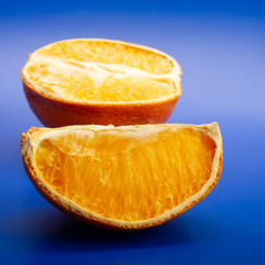 dry orange slices on a blue background. Web banner.