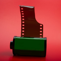 Old cassette with film on a red background.