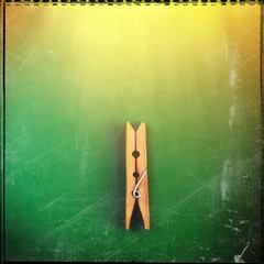 wooden clothespin on a green background. Web banner.