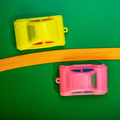 toy cars go to meet and a yellow ribbon on a green background.  Web banner.