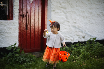 Toddler girl pretend playing Halloween party
