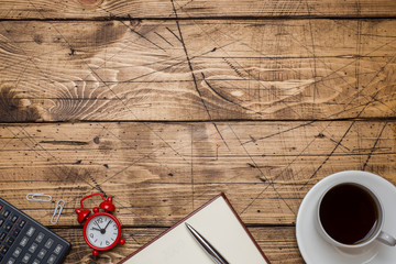 Notepad for text and Cup of coffee with copy space on wooden background. Education and office...