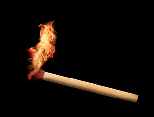 Matchstick burning on black background