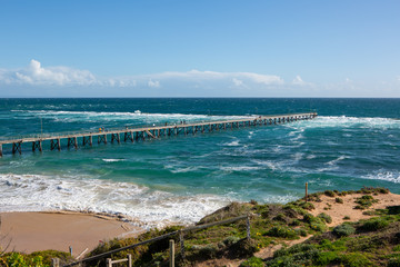 The Port Noarlunga Jetty in rough seas from the northern cliff face in South Australia on the 6th September 2018