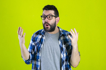 Portrait of young bearded man with shocked facial expression