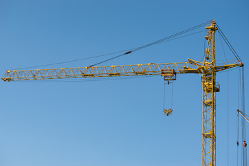 Large yellow crane and cloudless sky. Perfect background for a website or advertising your business