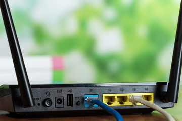 Connected connectors of a black router in a bright office