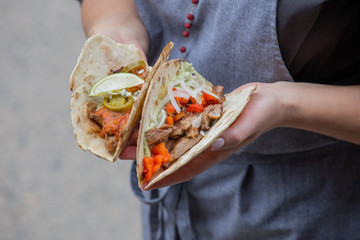 Takos with grilled chicken and guacamole and grilled pork and savory vegetable salsa on the grill.