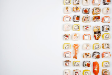 Sushi set with sushi rolls and sashimi on a blue background.