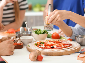 Friends cooking together in kitchen