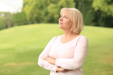 Obraz premium Portrait of beautiful mature woman outdoors