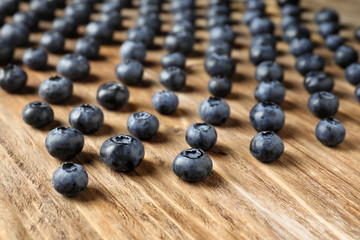 Ripe blueberries on wooden table