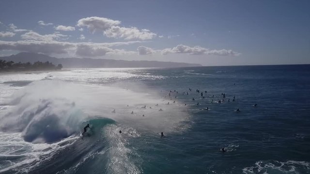 Big wave surfers out in the blue ocean. giant waves on beautiful sunny day