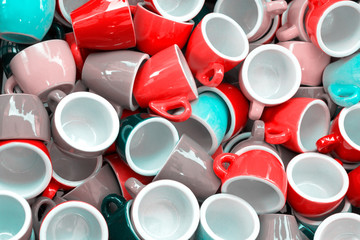 Heap of colorful pink, red, blue cups for espresso coffee - concept of coffee addiction and crockery products