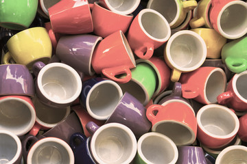 Heap of colorful cups for espresso coffee - concept of coffee addiction and crockery products